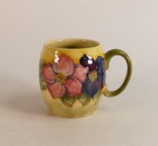 Moorcroft Clematis mug on faded yellow/green Background