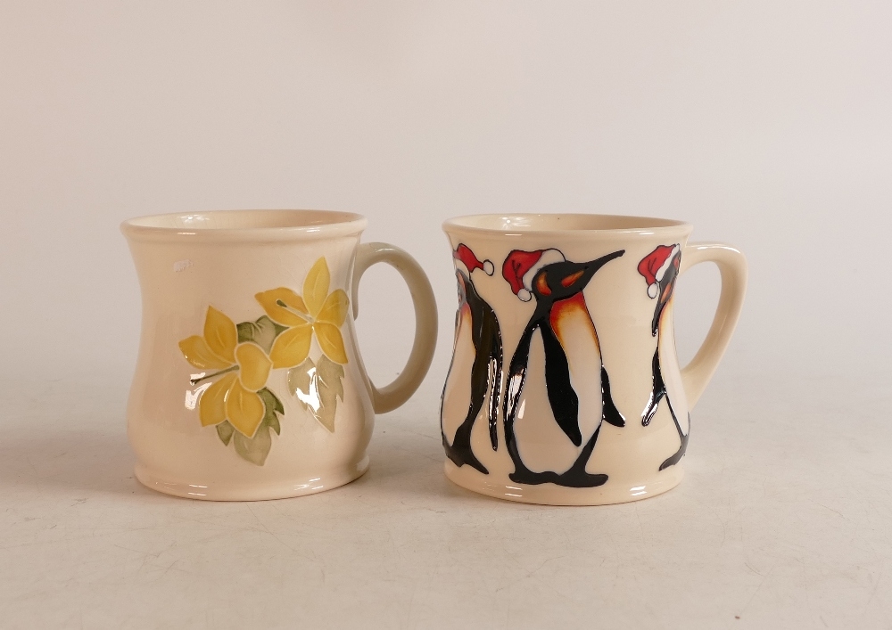 Two Moorcroft mugs to include Christmas penguins and yellow floral mig (2)
