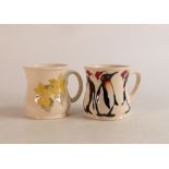 Two Moorcroft mugs to include Christmas penguins and yellow floral mig (2)