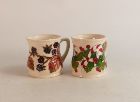 Two Moorcroft mugs to include Bramble (crazed) and Christmas Candlesticks (2)