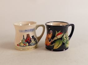 Two Moorcroft mugs to include Moorcroft museum and Empire butterfly (2)