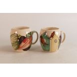 Two Moorcroft barrel mugs to include Vegetable patch and Bird houses and birds (2)