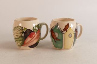 Two Moorcroft barrel mugs to include Vegetable patch and Bird houses and birds (2)