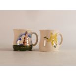 Two Moorcroft mugs to include daffodil and Bootle Kiln (crazing) (2)