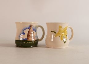 Two Moorcroft mugs to include daffodil and Bootle Kiln (crazing) (2)