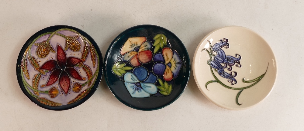 Three Moorcroft pin dishes to include Bluebell Harmony, Triple Choice (M.C.C, seconds) and