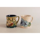Two Moorcroft Mugs to include strawberries and wild berries together with blue pansies (crazed) (2)