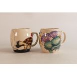 Two Moorcroft barrel mugs to include Tortoise & hare and thistle (2)