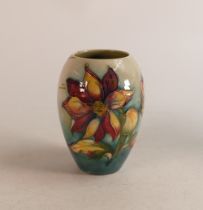 Early Moorcroft Dalia vase on faded green ground. Height 12.5cm