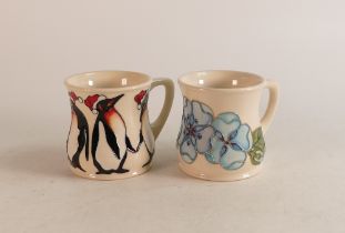 Two Moorcroft mugs to include Blue Pansy and Christmas Penguins (2)