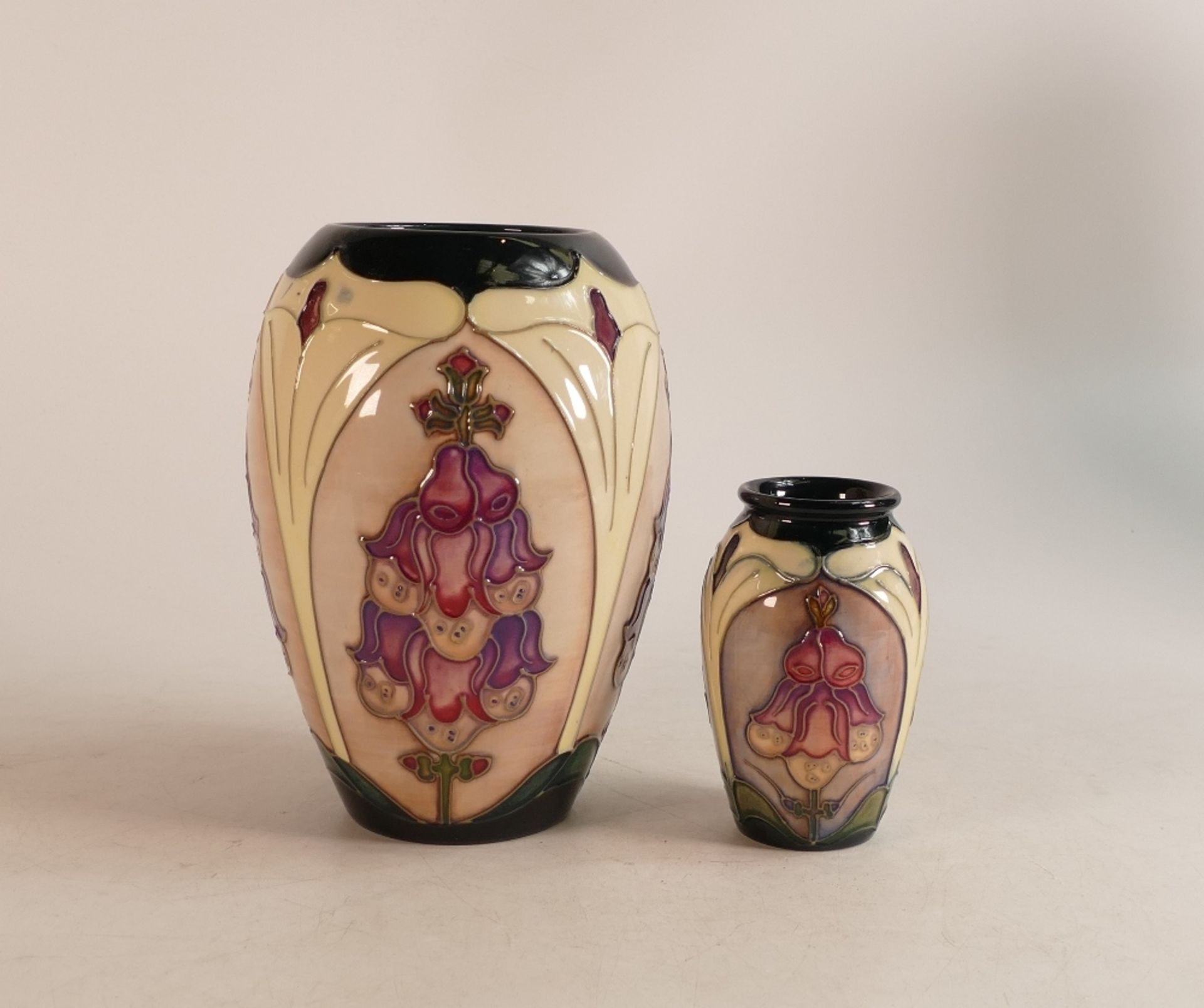 Two Moorcroft Foxglove vases. Height of tallest 19cm