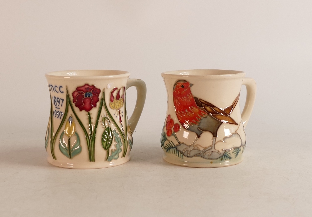 Two Moorcroft mugs to include MCC 1897-1997 (crazed) and Robin mug (2)