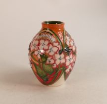 Moorcroft Trial vase decorated with pink flowers on orange background. Height 15cm