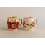 Two Moorcroft Mugs to include Apple and Christmas mug decorated with pies, holly and stars (2)