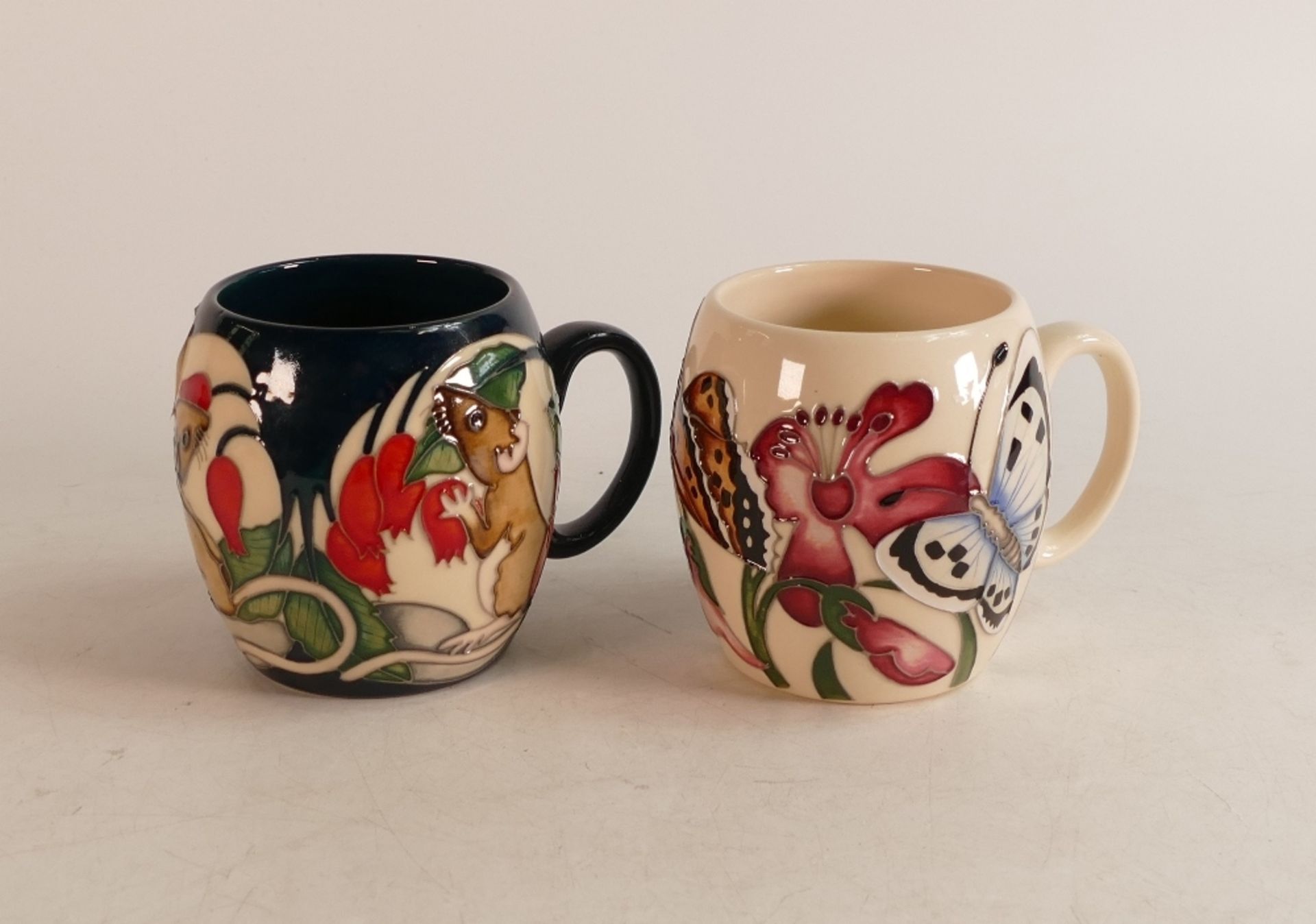 Two Moorcroft barrel mugs to include Field mouse and Butterflies (2)