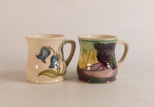 Two Moorcroft mugs to include Bluebells (slight crazing) and M.C.C 1991 (2)
