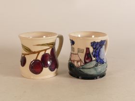 Two Moorcroft mugs to include Plums and M.C.C 1992 (2)