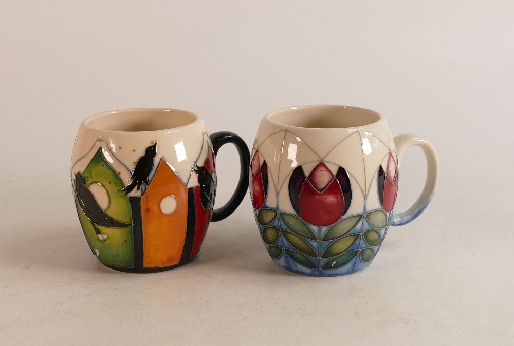 Two Moorcroft trial Mugs to include birds singing on the birdhouse and red/ purple flowers on blue/