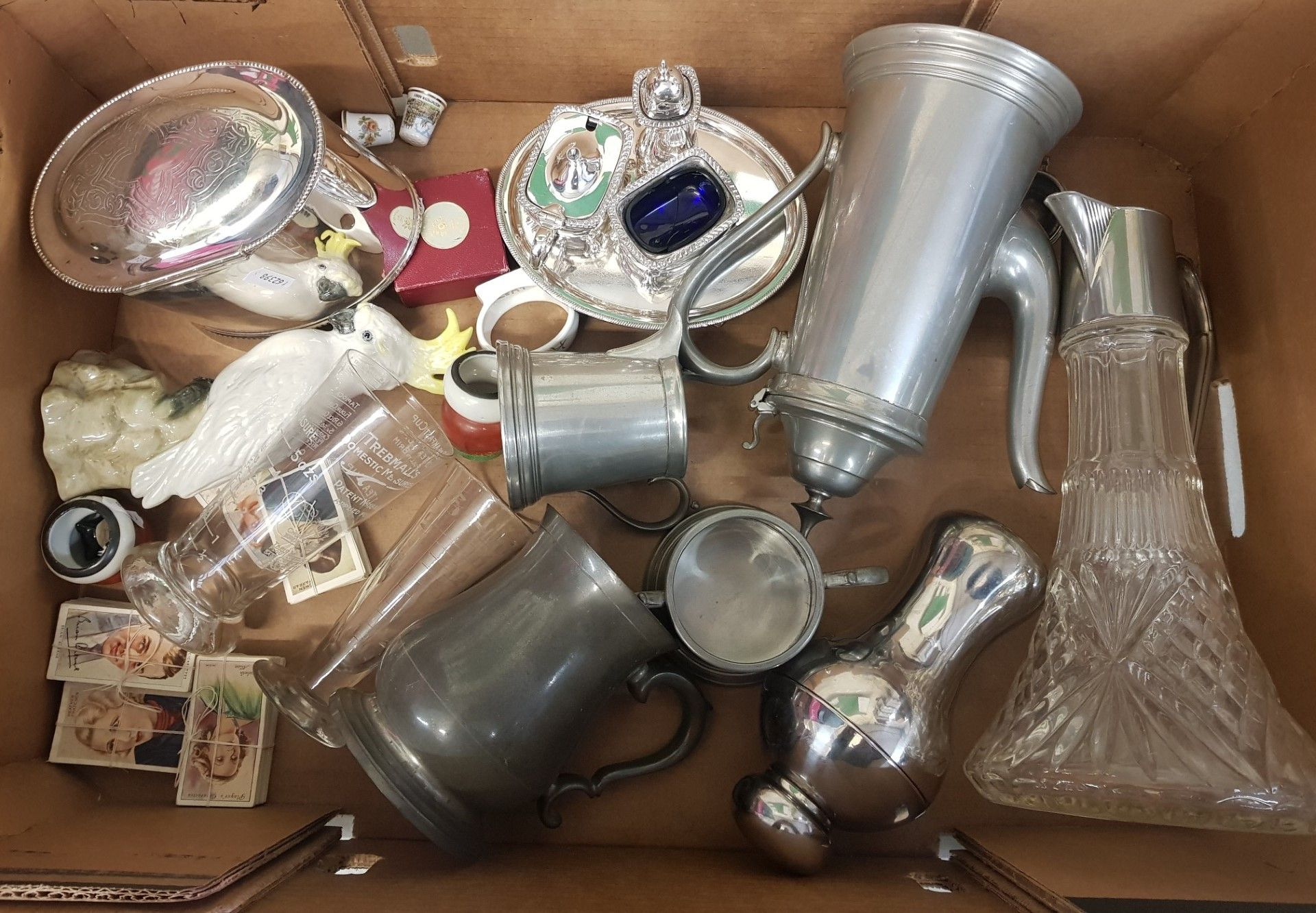 A mixed collection of items to include a claret jug, pewter tea service items, silver plated cruet
