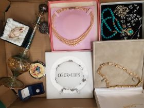 A collection of costume jewellery consisting of cased necklaces, a tall art glass perfume bottle,