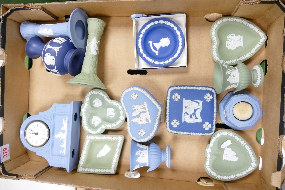 A collection of Wedgwood Jasperware to include Dancing Hours candlesticks, mantle clock, pin dishes,