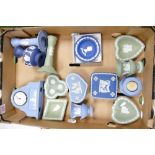 A collection of Wedgwood Jasperware to include Dancing Hours candlesticks, mantle clock, pin dishes,