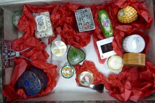 A collection of small enamel, pottery & paper mache lidded boxes