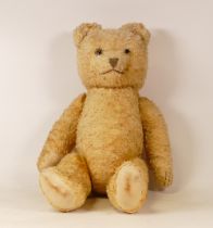 A 20th Century Teddy Bear. Arms and Legs have joints connecting by strings, plastic eyes, three sewn