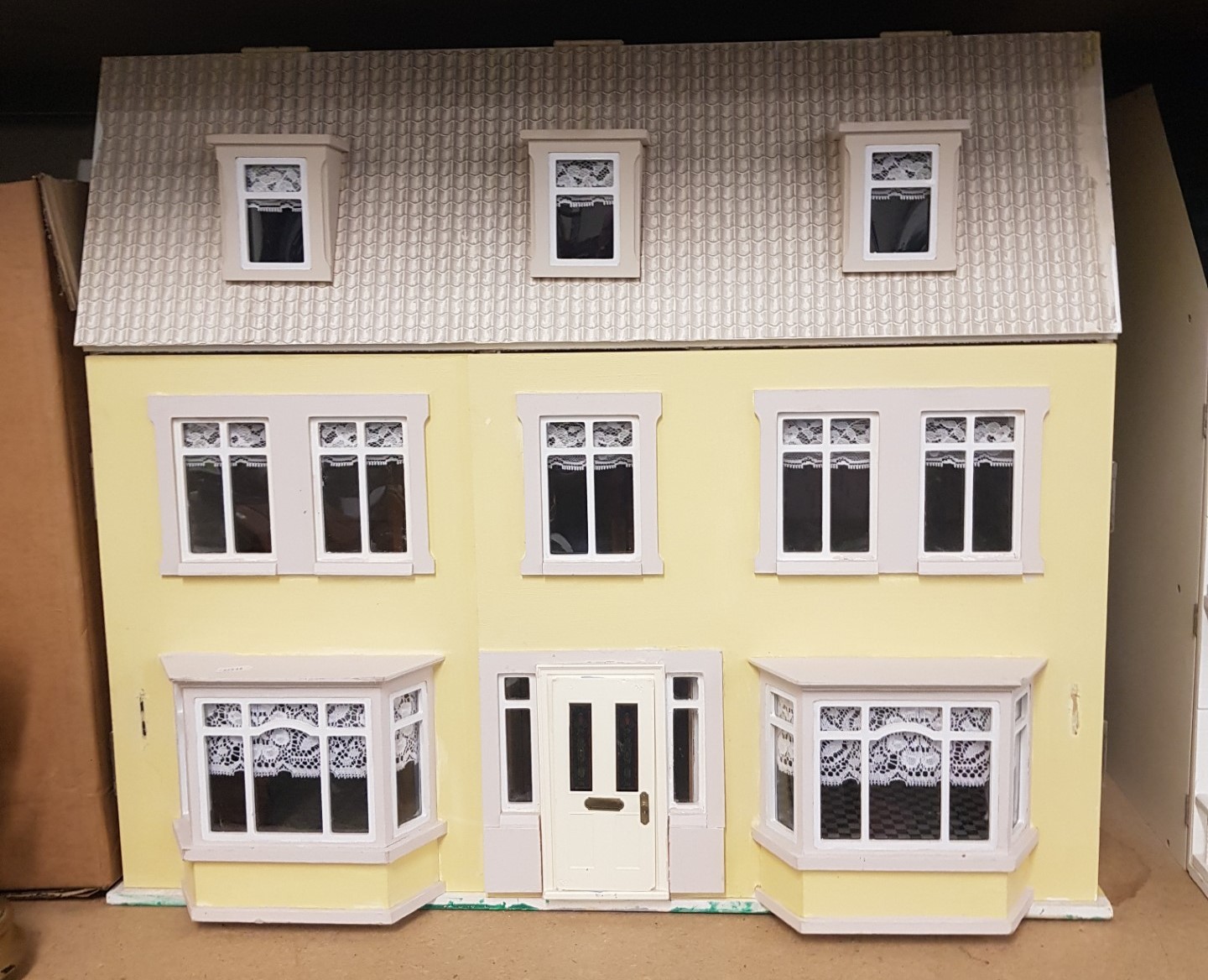 Large 3 story dolls house in yellow, 76cm in width.