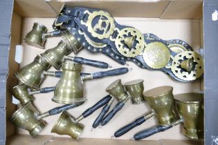 A collection of reproduction brass measures & horse brasses