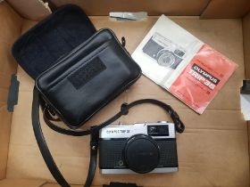 An Olympus Trip 35 camera, with case and instruction booklet.
