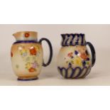 Carlton Ware Camellia patterned jug together with a Polyanthus patterned jug. Height 16cm (2)