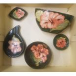 A collection of Moorcroft Hibiscus on green ground items to include small footed bowl, window sil