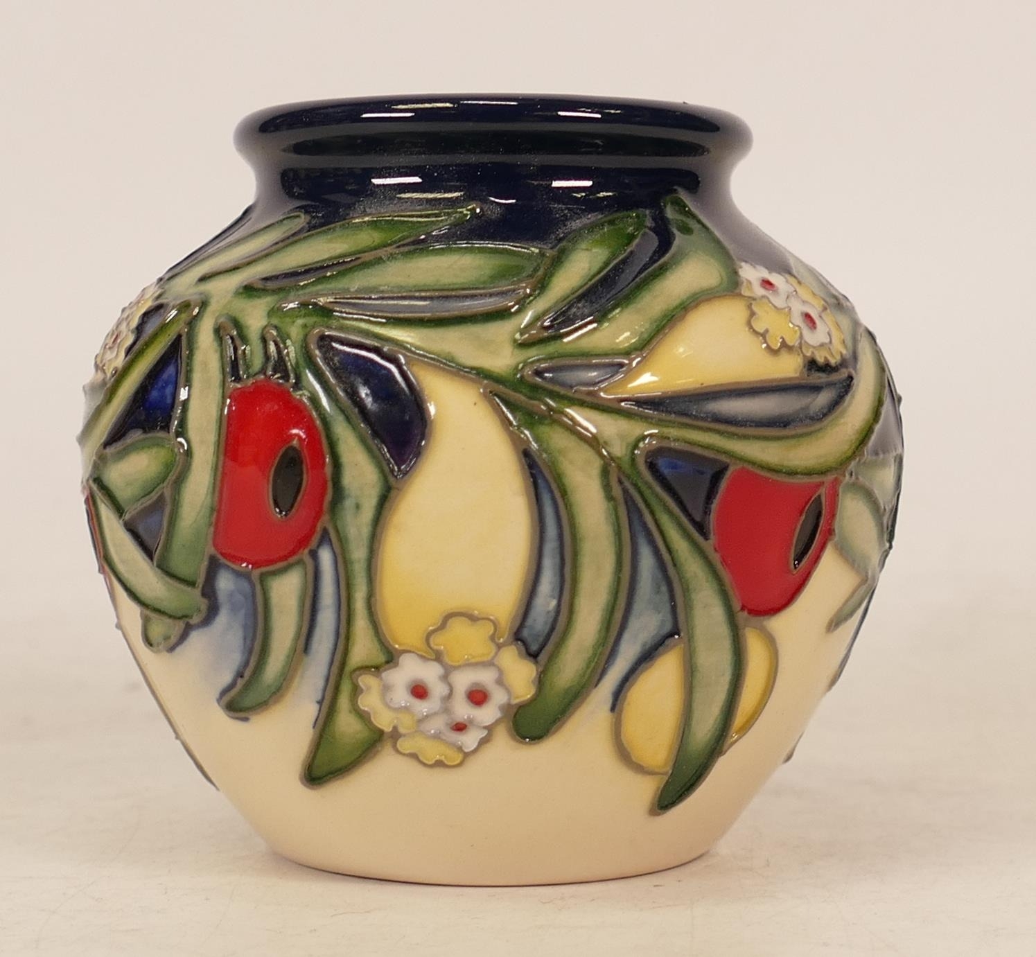 Moorcroft limited edition vase decorated with red berries and green foliage on blue and cream