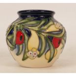 Moorcroft limited edition vase decorated with red berries and green foliage on blue and cream