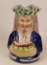 A Mid Victorian Staffordshire Toby Jug with Game Basket and Merry Christmas in gilt letters below.