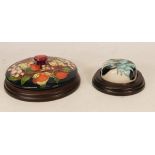 Two Moorcroft paperweights in the Winter Harvest pattern and Sea Holly