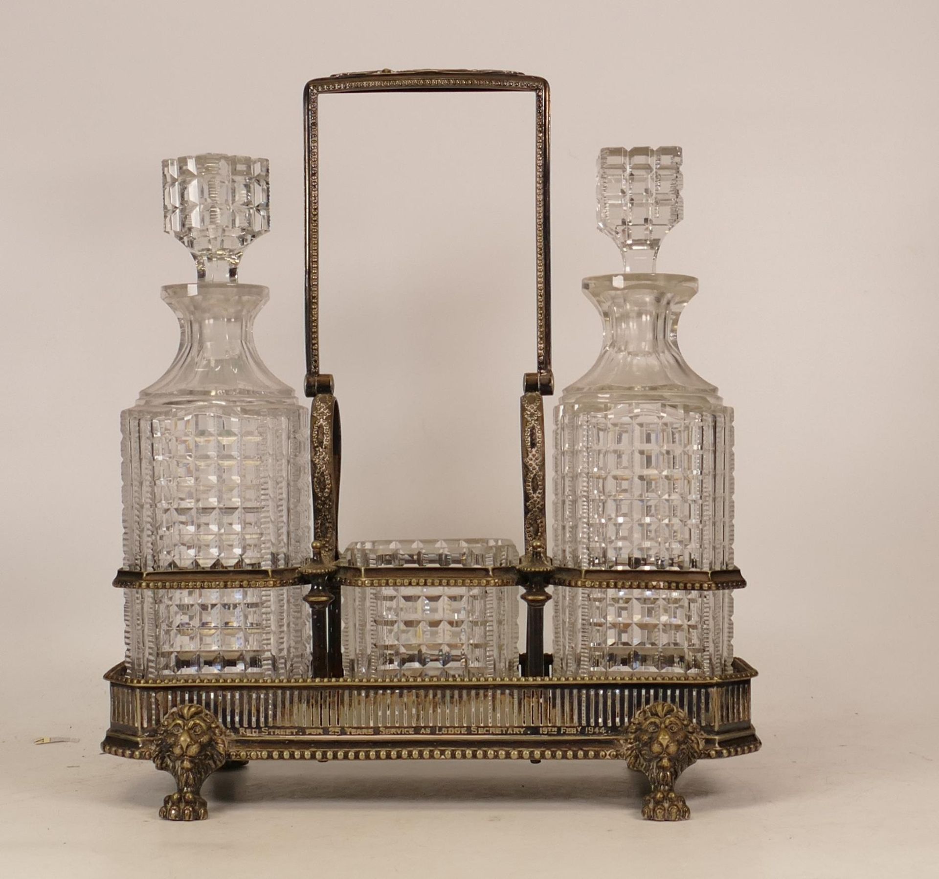 A Silverplate Crystal Glass Tantalus Set, Two Decanters and Bowl