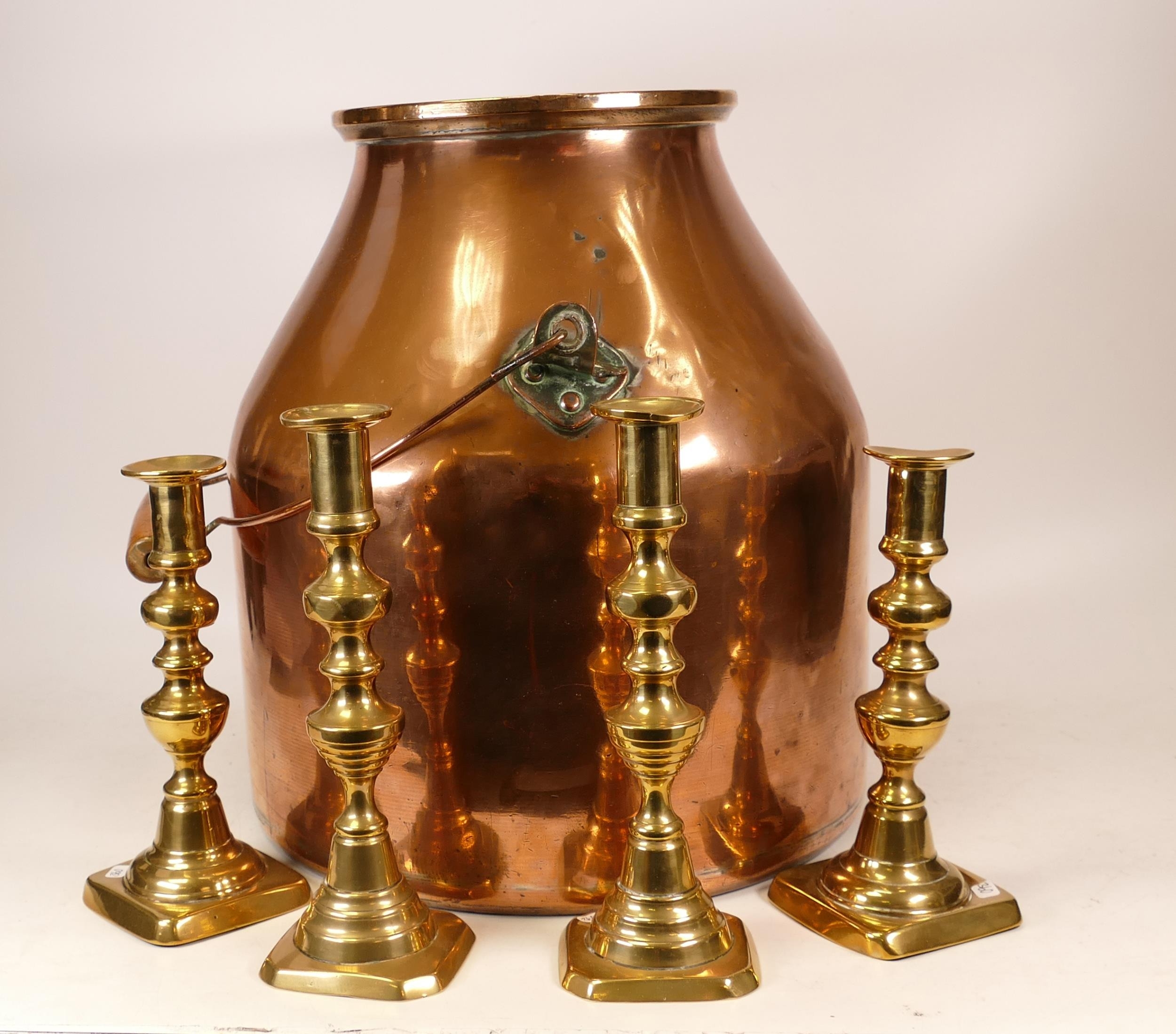 Copper milk churn together with 4 brass candlestick holders (5)