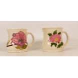 Moorcroft mug of the year 1987 (a/f) and Moorcroft mug decorated with a pink flower (2)