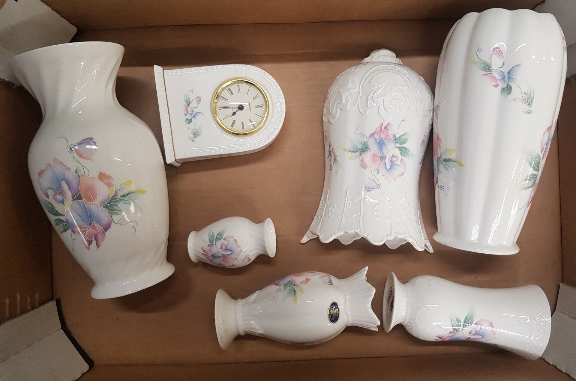A collection of Aynsley 'Little Sweethearts' pattern items to include a mantle clock, vases, wall