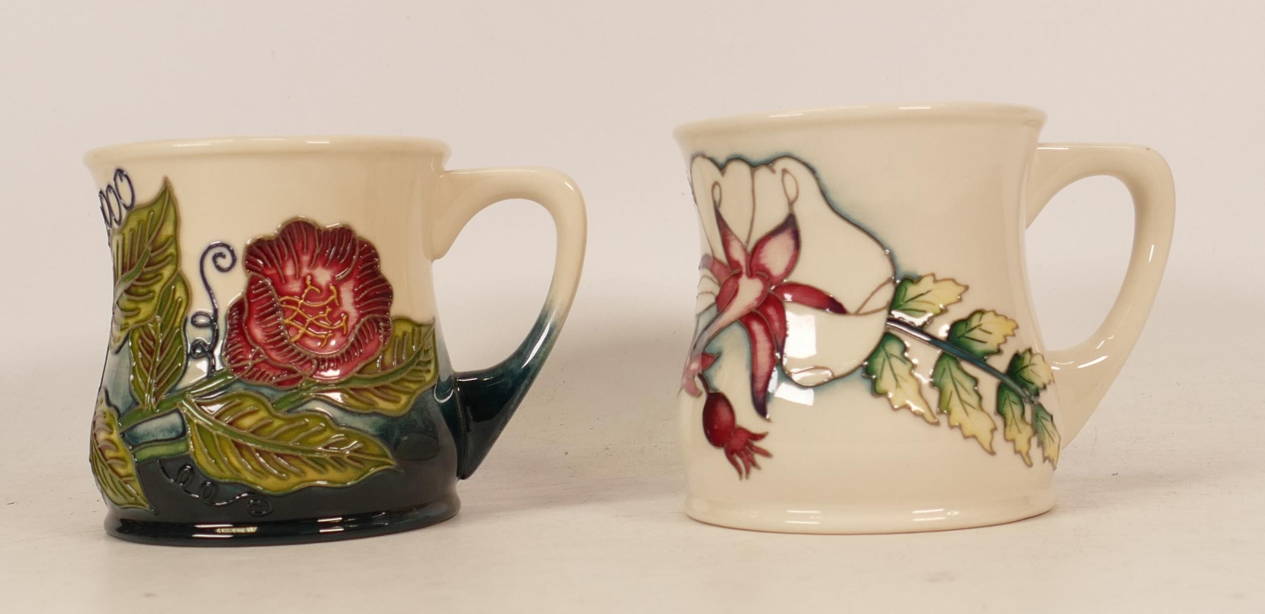 Moorcroft mug of the year 2000 together with mug decorated in white flowers with blue/ white