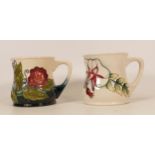 Moorcroft mug of the year 2000 together with mug decorated in white flowers with blue/ white