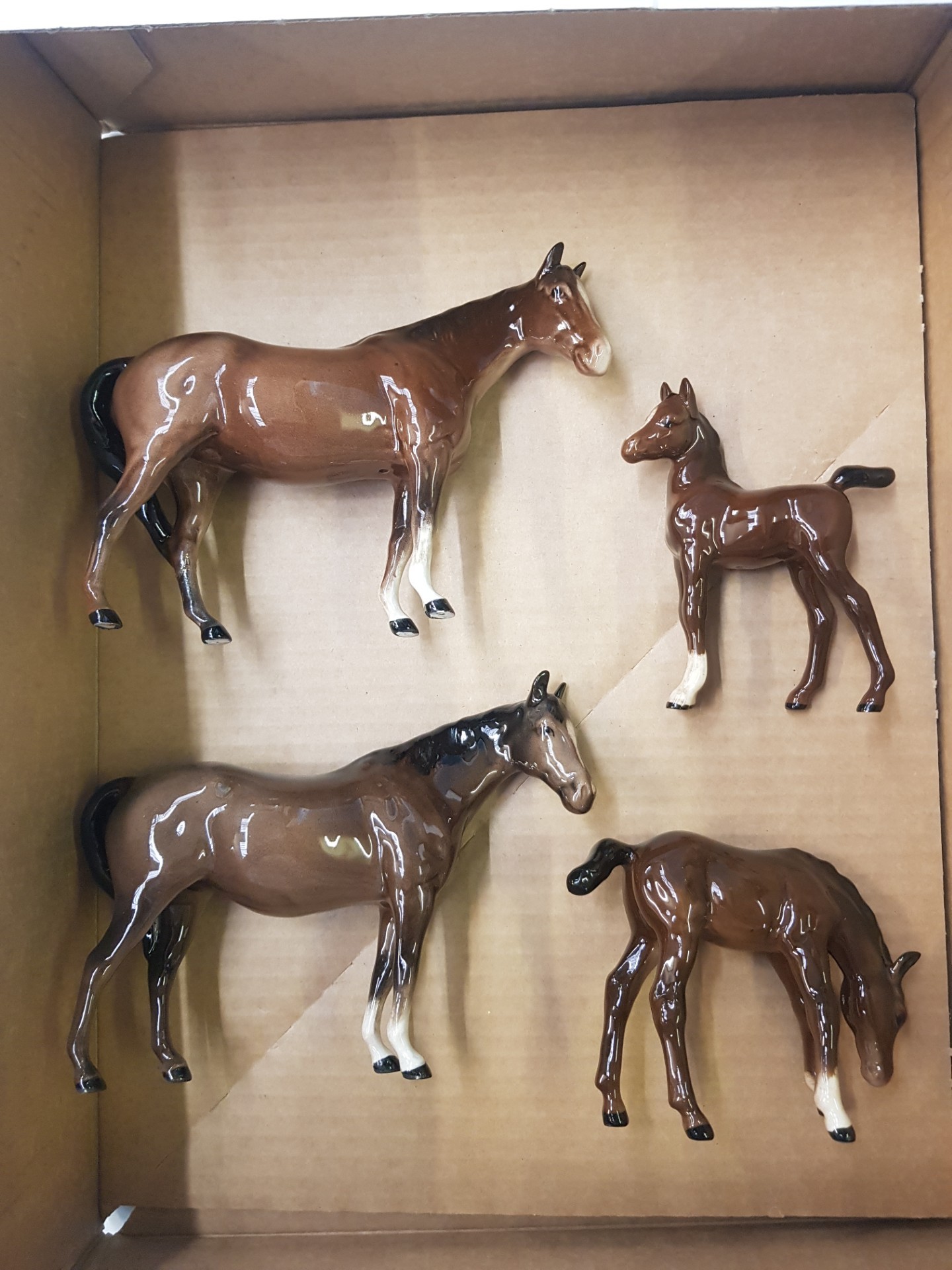 A collection of Beswick horses and foals to include 2 brown mares and 2 brown foals (4).