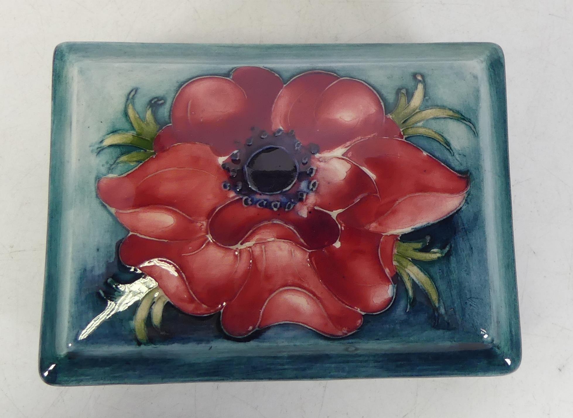 Moorcroft Anemone lidded box on blue ground. L. 13cm