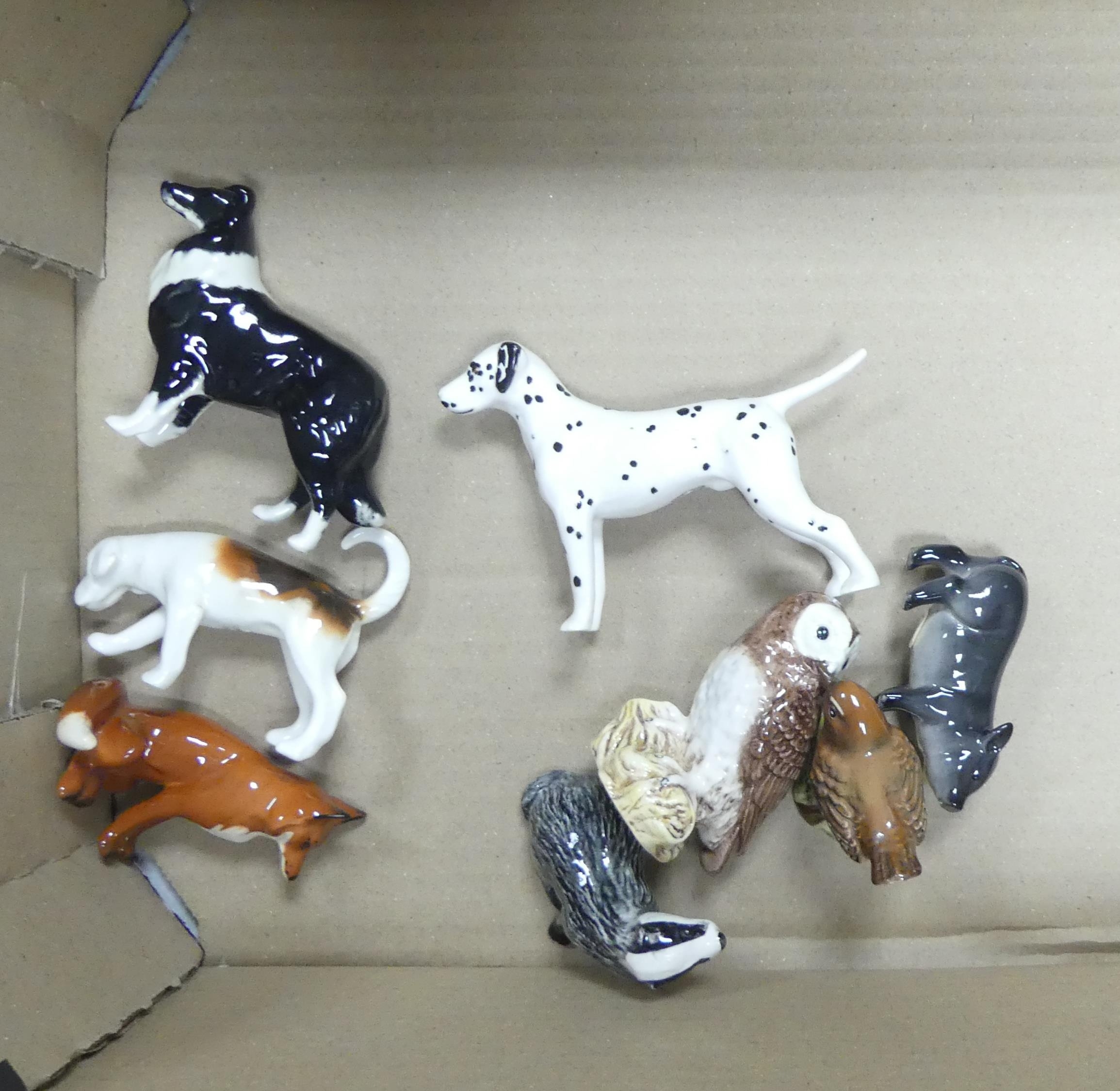 A collection of Beswick animals to include small seated fox, foxhound, sheep dog, dalmatian, badger,