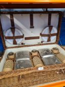 A wicker picnic basket and contents manufactured by Coracle, relevant to the 1920s/30s
