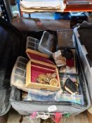 A selection of costume jewellery and a selection of coins in a suitcase