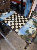 An oblong coffee table, the top decorated chess board and swans made from feathers