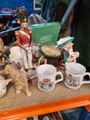 A selection of ceramic and resin figures, some depicting animals and soldiers